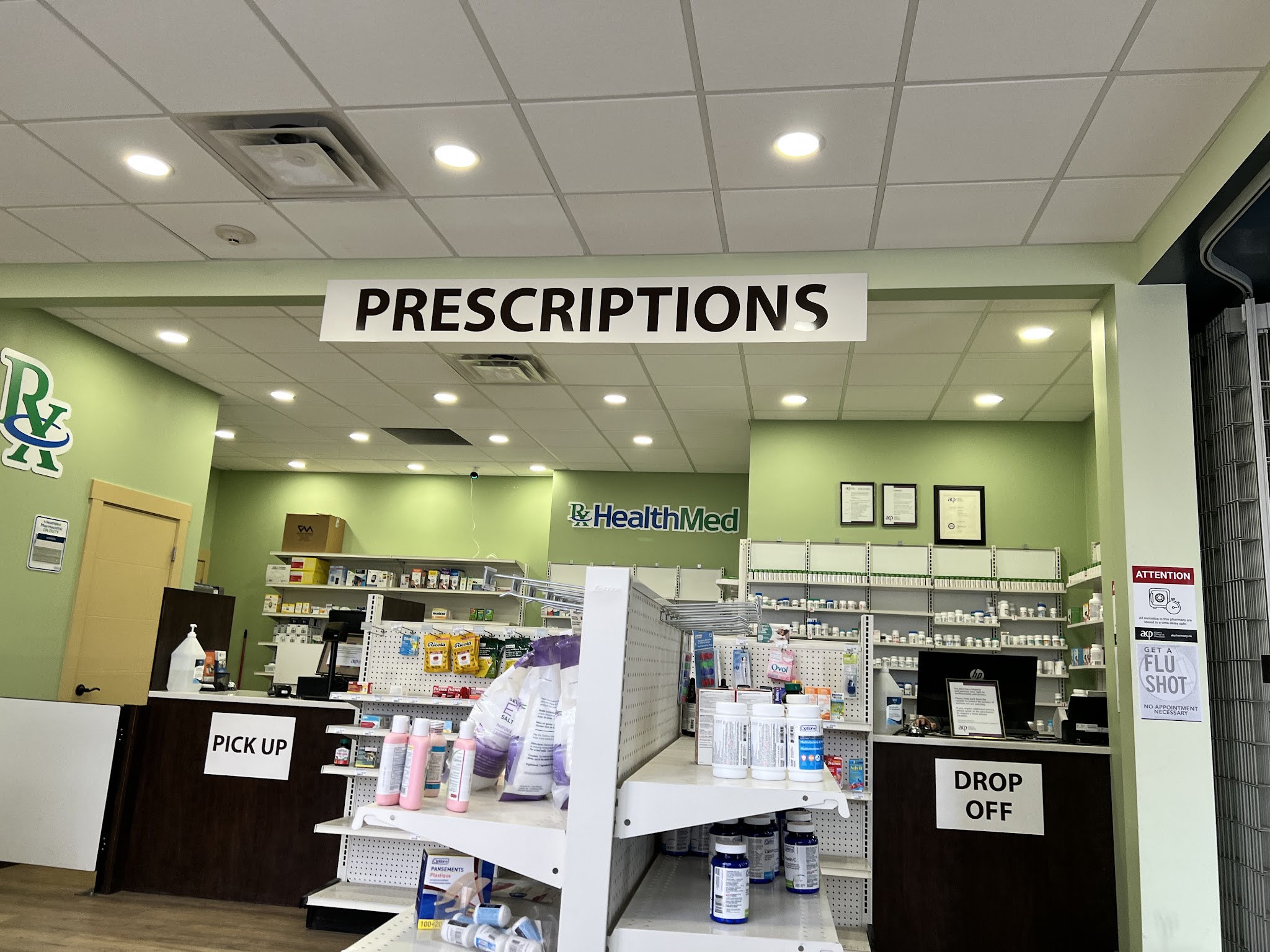 Pharmacy 66 prescription counter with PICK UP and DROP OFF areas and FLU SHOT signage
